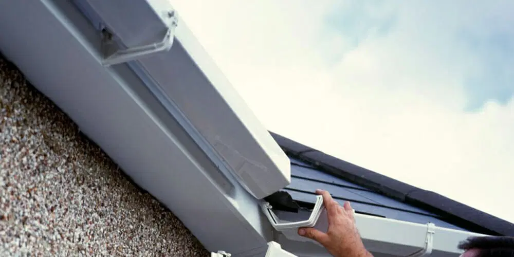 A hand of a man cutting gutters